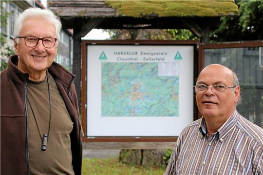 Rainer Habich (links) und Werner Mootz präsentieren die neue Wanderkarte, die der Harzklub vor der Zellerfelder Apotheke aufgestellt hat. Foto: Knoke