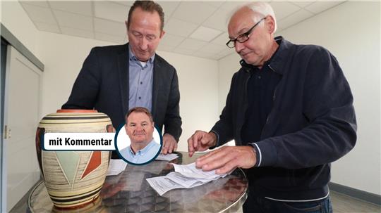 Zwei Männer zählen Stimmzettel aus.