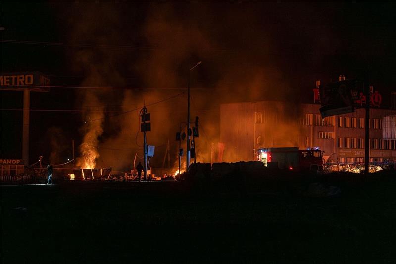Tote und Verletzte nach russischen Angriffen auf Charkiw Rettungskräfte löschen das Feuer in Charkiw.