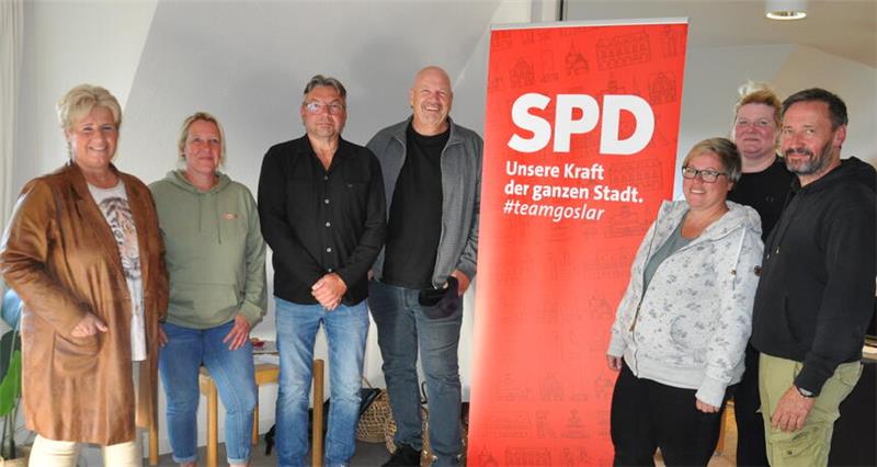 Sieben Personen stehen in einem Raum vor einem roten SPD-Aufsteller mit dem Text 'Unsere Kraft der ganzen Stadt. #teamgoslar'