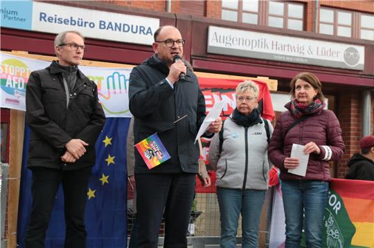 Seesens Bürgermeister Erik Homann steht mit weiteren Personen zusammen und hält eine Rede.