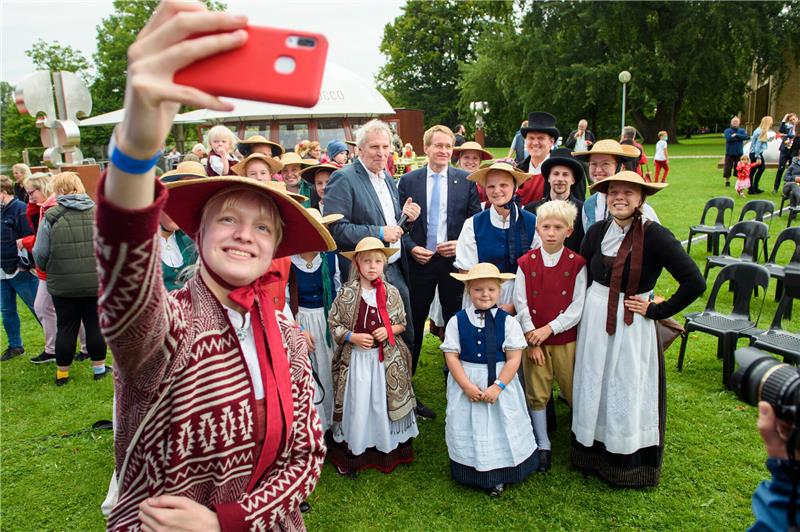 Selfie mit Regierungschef: MinisterpräsidentGünther (M.) und Tänzerinnen eines Traditionsvereins während eines Bürgerfestes. Foto: PA/dpa
