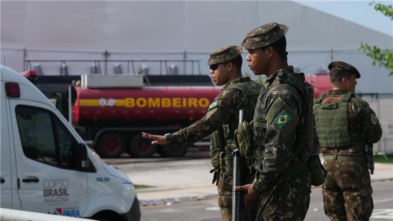 Sicherheitskräfte leiten Fahrzeuge nach einem Brand auf dem Gelände der Weltklimakonferenz.