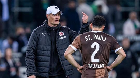 St. Paulis Manolis Saliakas (r) im Gespräch mit Trainer Alexander Blessin. Im Testspiel bei Eintracht Braunschweig erzielt der Abwehrspieler ein Eigentor. 