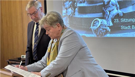 Susanne Herweg unterzeichnet im Beisein von Bürgermeister Ralf Abrahms die notwendigen Papiere, die für den Einzug in den Rat notwendig sind.