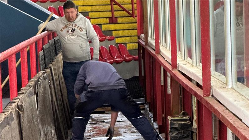 Sven Jakubczik und Alexander Deibert entfernen die Abdeckung des Kältekanals im Eisstadion.