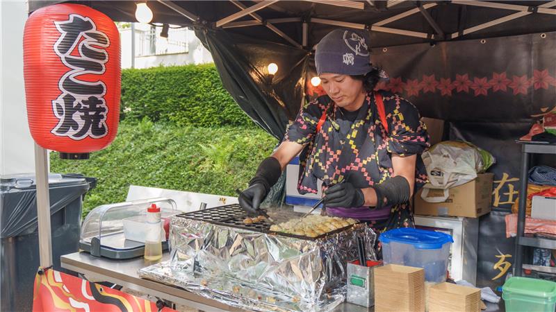 Ein japanischer Food-Truck-Betreiber bereitet Takoyaki zu: Das sind Teigbällchen mit Oktopus-Füllung.