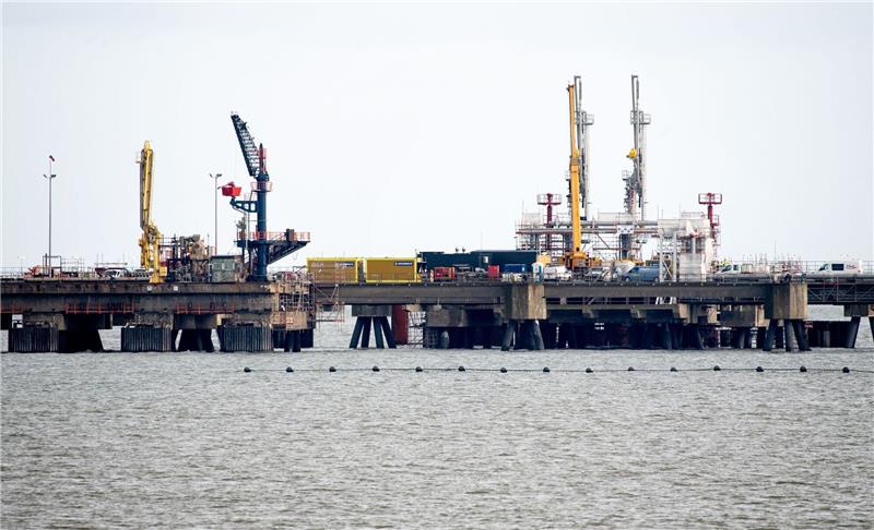 Technische Anlagen und ein Kran stehen auf dem Anleger für das LNG-Terminal vor Wilhelmshaven.