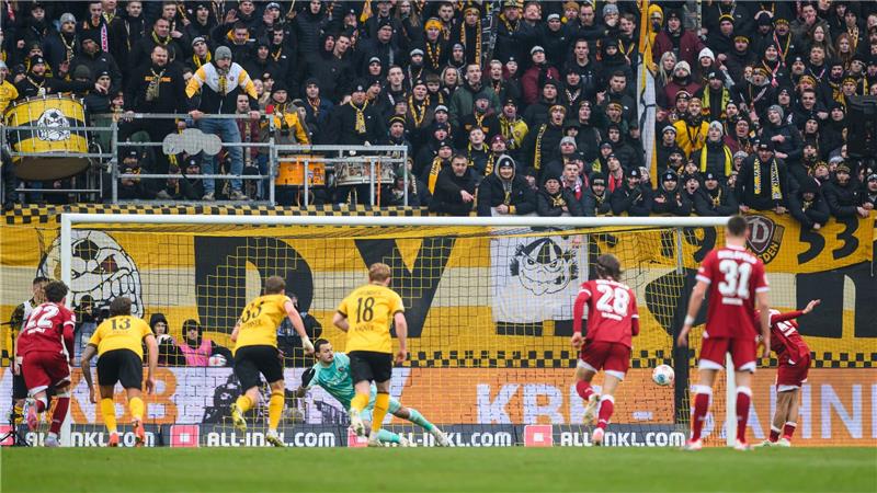 Torwart Tim Schreiber (Dynamo Dresden) kann einen Elfmeter zum 1:1 durch Tim Handwerker (Arminia Bielefeld, r) nicht halten.