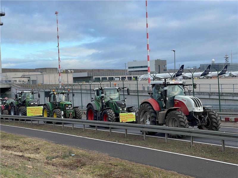 Bauern protestieren am Frankfurter Flughafen Traktoren fahren auf einer Straße am Flughafen Frankfurt vorbei. Wie ein Polizeisprecher sagte, begaben sich die Bauern am Morgen gegen 6 Uhr Richtung Airport. Geplant sei eine Protestfahrt rund um das Gelände.