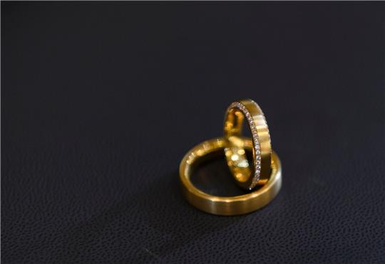 Trauringe auf schwarzem Untergrund. Eine ehrliche Finderin hat eine Schachtel mit zwei Ringen auf der Straße gefunden, sich bei der Polizei gemeldet und damit einen Heiratsantrag an Heiligabend möglich gemacht (Symbolbild).