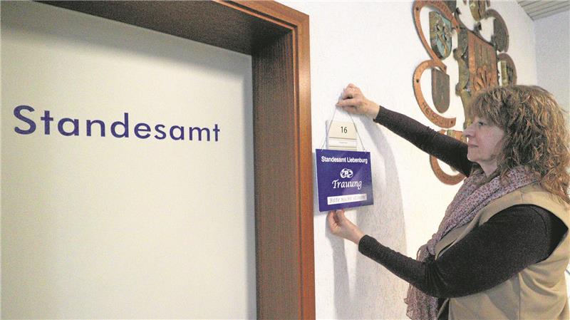 Nach 2500 Trauungen ist für Liebenburgs Standesbeamtin Schluss Eine Frau hängt ein Schild neben eine Tür.