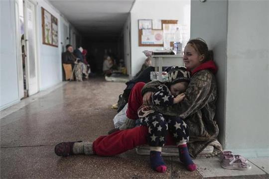Voller Trauer und Verzweiflung: Anastasia Erashova umklammert im Flur eines Krankenhauses in Mariupol ihr Kind. Zwei weitere Kindervon ihr wurden während des Beschusses der Stadt getötet. Foto: Evgeniy Maloletka/dpa