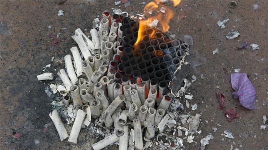 Eine abgeschossene Silvesterböller-Batterie brennt.