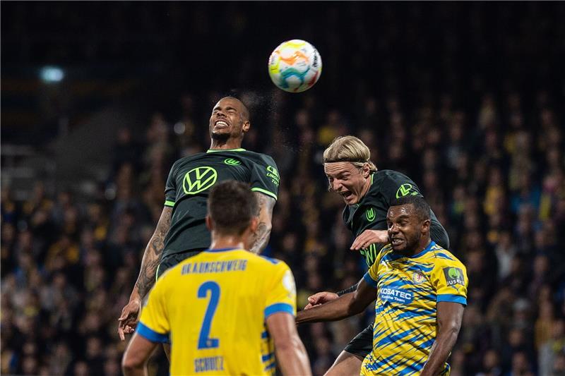 Wolfsburg gewinnt Pokalderby gegen Braunschweiger Notelf Wolfsburgs Lukas Nmecha (l) und Sebastiaan Bornauw in Aktion gegen Braunschweigs Anton Donkor (r) und Michael Schultz.