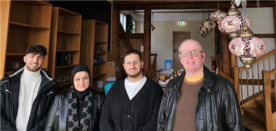 Yusuf (von links), Saadet und Abdullah Celik freuen sich mit Hausbesitzer Peter Reich über das neue Waffeleisen.  Foto: Sowa