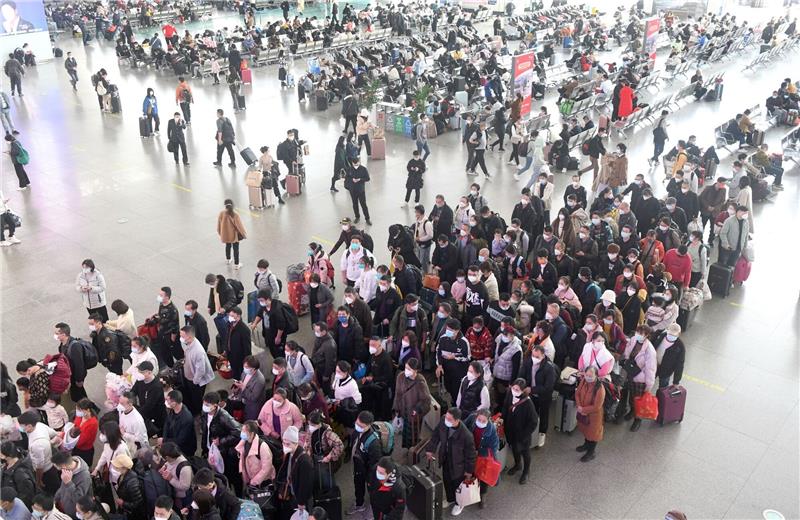 Erster Besucherstrom in China nach Ende von Null-Covid Zahlreiche Fahrgäste stehen in einem Bahnhof in der südchinesischen Provinz Guangdong Schlange.