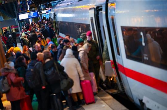 Zahlreiche Reisende warten auf einem vollen Bahnsteig am Hauptbahnhof auf ihren Zug.